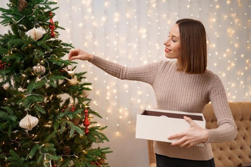 young girl decorating tree